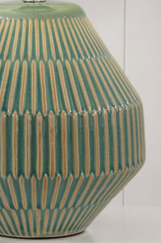 Green textured ceramic based table lamp with a white fabric shade.