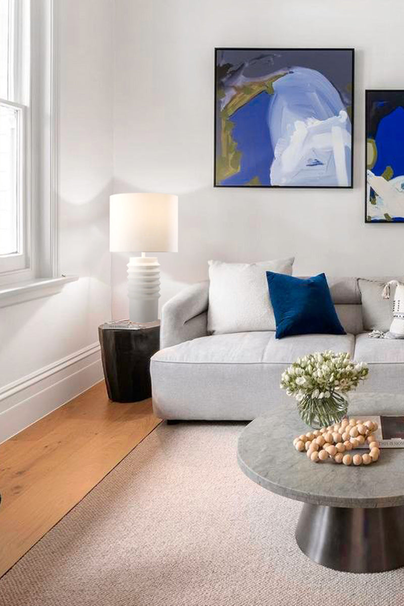 White ceramic and fabric shade on the side table in a fresh lounge room. 
