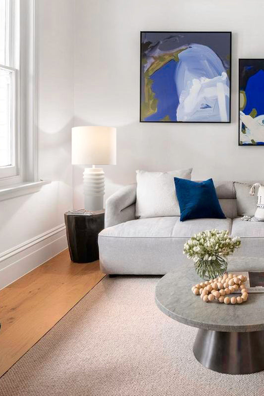 White ceramic and fabric shade on the side table in a fresh lounge room. 