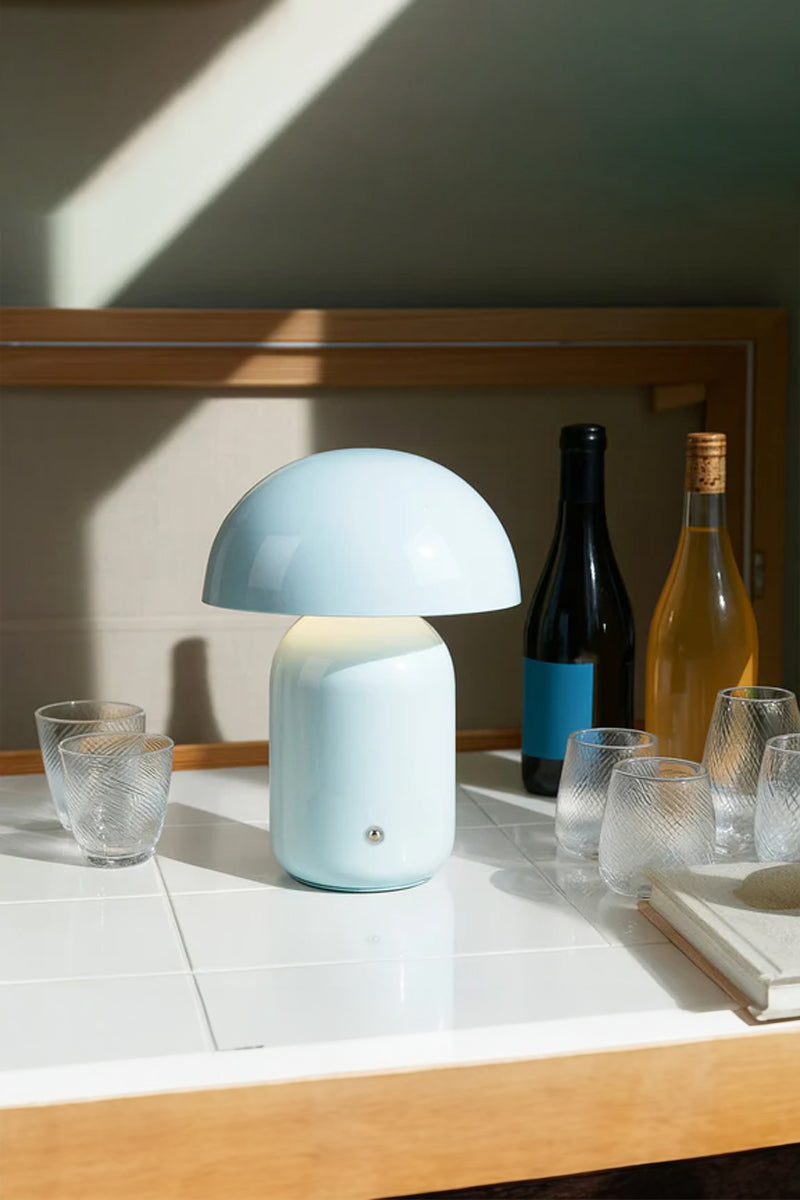 Blue illuminated LED mushroom lamp on a drinks station. 