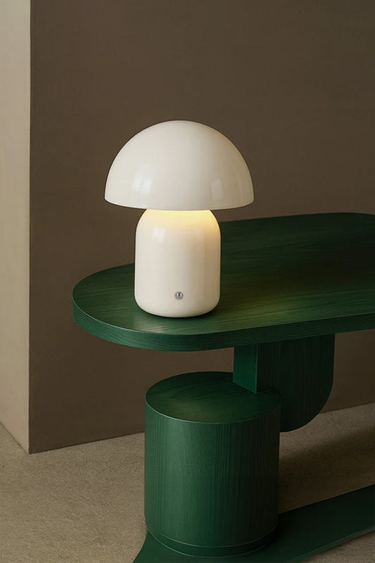 White  illuminated LED mushroom lamp on a modern green side table. 