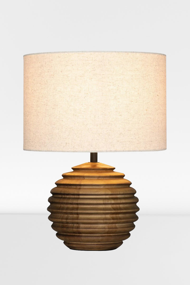 Wooden based table lamp with a ribbed circular shade and a natural linen shade. 