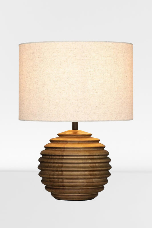 Wooden based table lamp with a ribbed circular shade and a natural linen shade. 