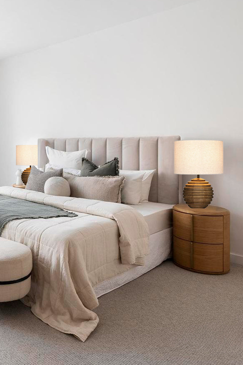 Two wood based table lamps with fabric shades as bedside lamps. 