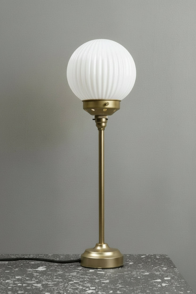 Opal reeded glass ball shade on a black candle stick table lamp stand. 