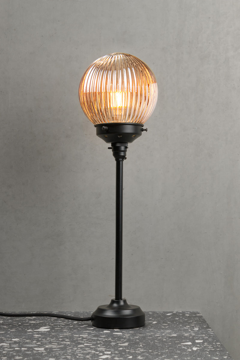 Black candle stick lamp stand with a dark amber reeded glass ball shade. 