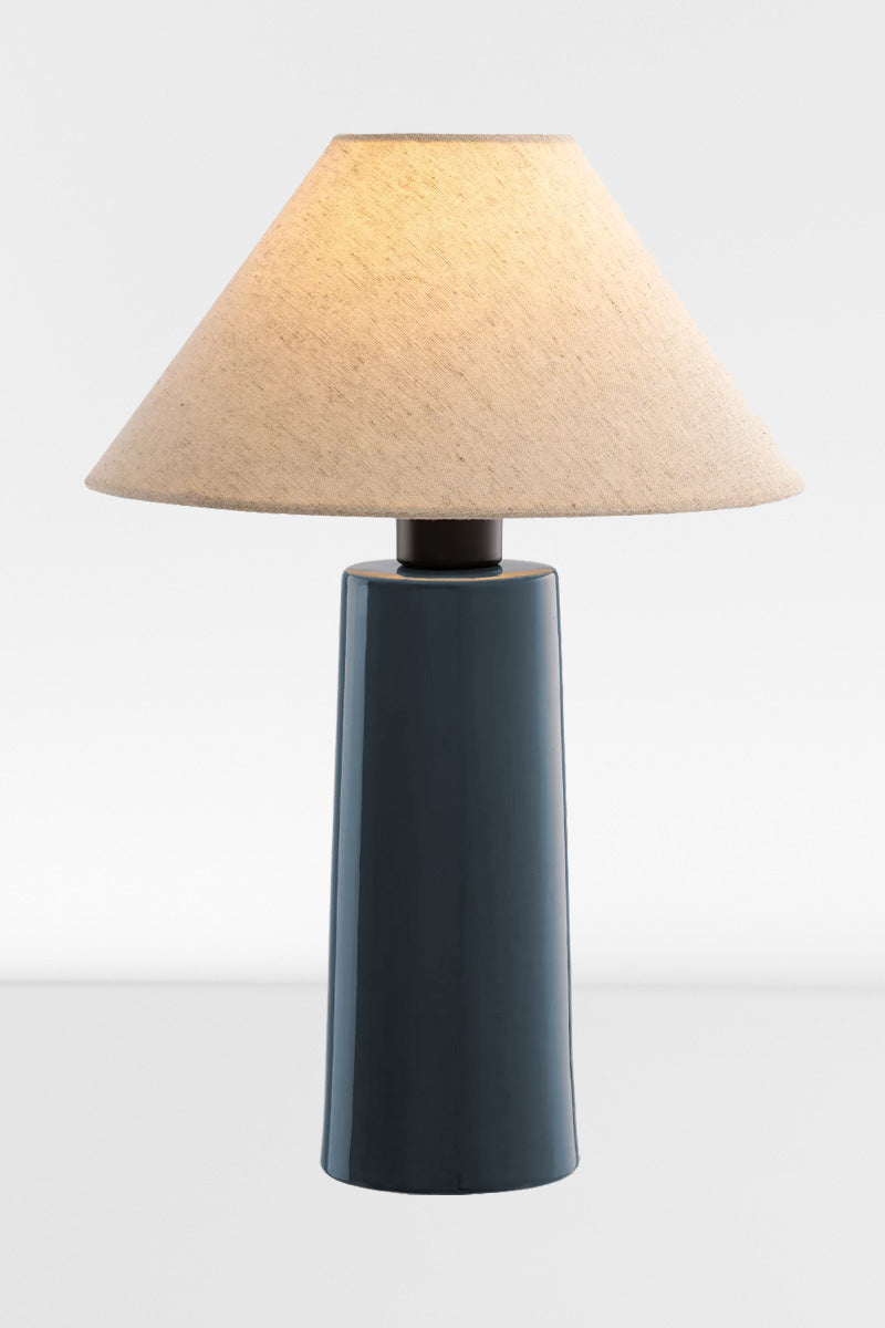 Blue ceramic table lamp with linen shade. 