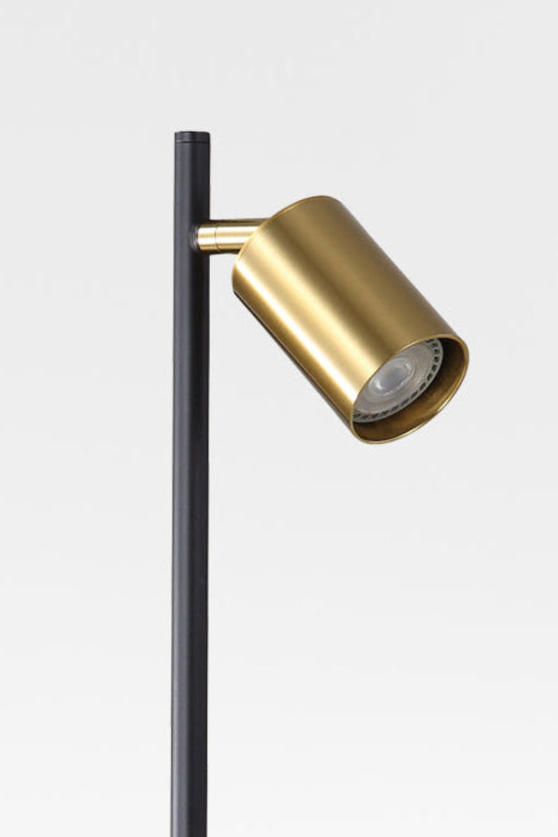 Close up of the  desk lamp with satin brass spot headand, black stand and light off. 