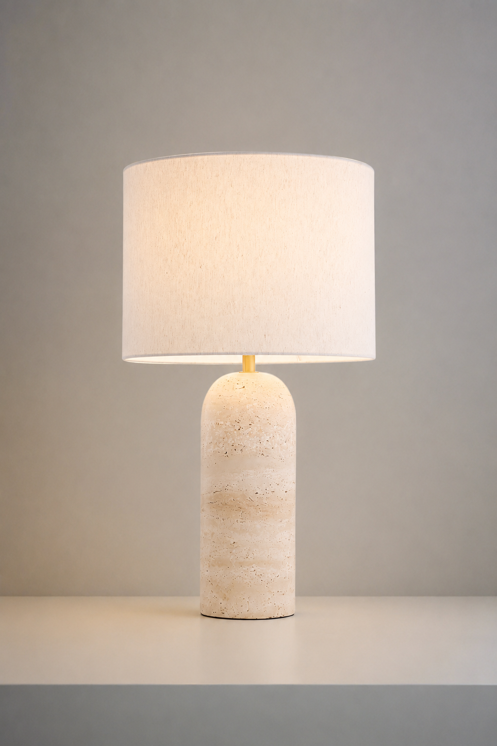  Table lamp with a drum shade and travertine base. 