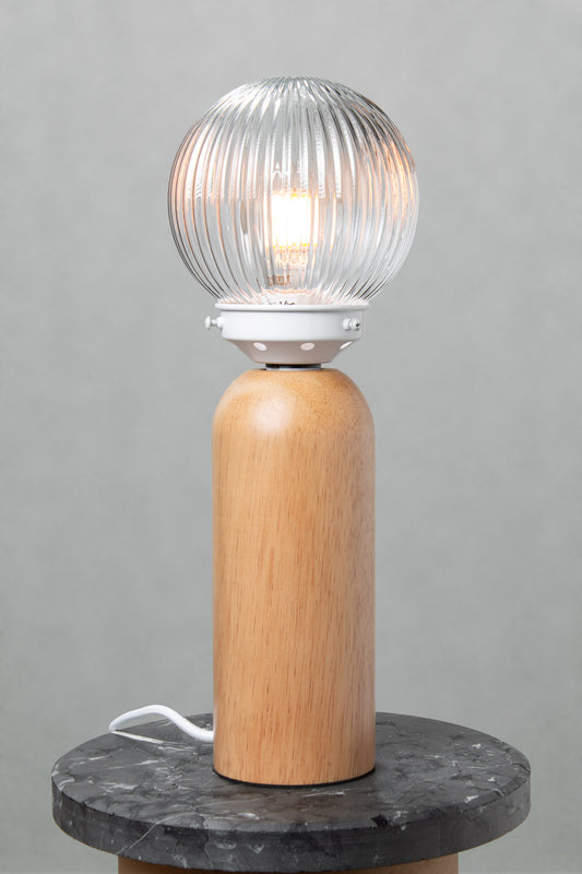 Dakota Wood Table Lamp with clear reeded glass shade illuminated