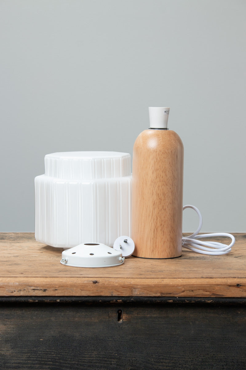 Harcourt Wood Table Lamp with opal glass shade and natural wood base, with shade components displayed beside it.