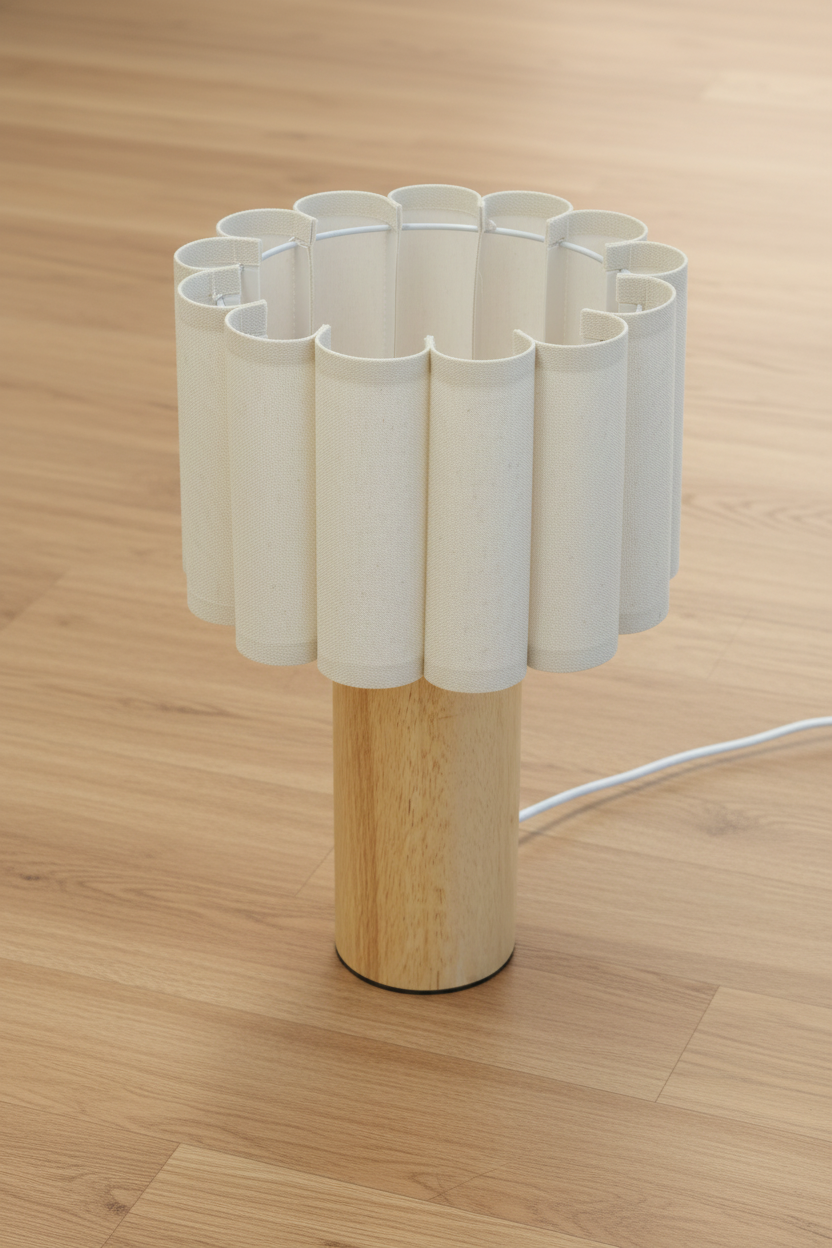 Natural fabric shade with scalloped detailing on a white metal frame, paired with a wood block table lamp base. 