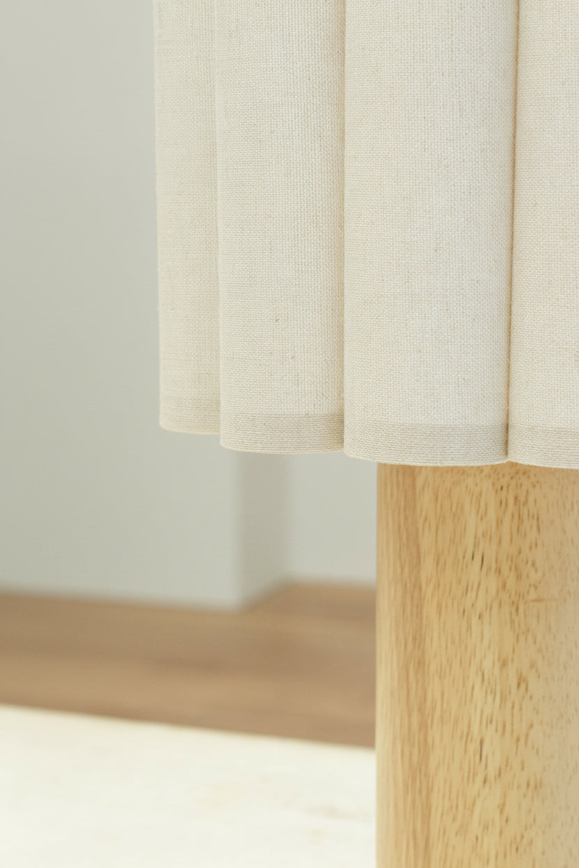Close up of the scalloped detailing on the fabric shade and top of the timber base. 