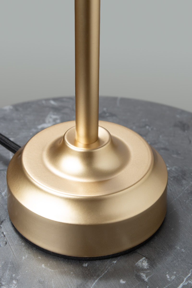 Close up of the base on the gold/brass candlestick table lamp base. 