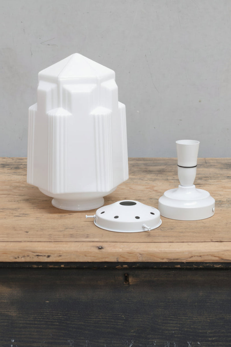 Art Deco inspired opal glass shade, sitting on a timber bench with a white gallery and batten holder. 