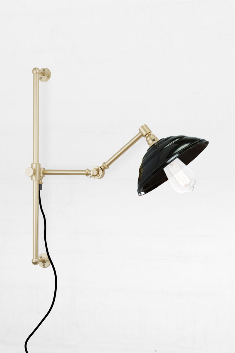 Swing Arm Wall Lamp in gold arm finish with Bakelite shade and teardrop bulb
