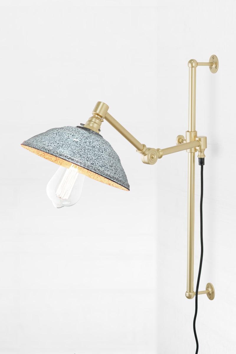Swing Arm Wall Lamp in gold/brass arm finish with white/black Bakelite shade and tear drop bulb