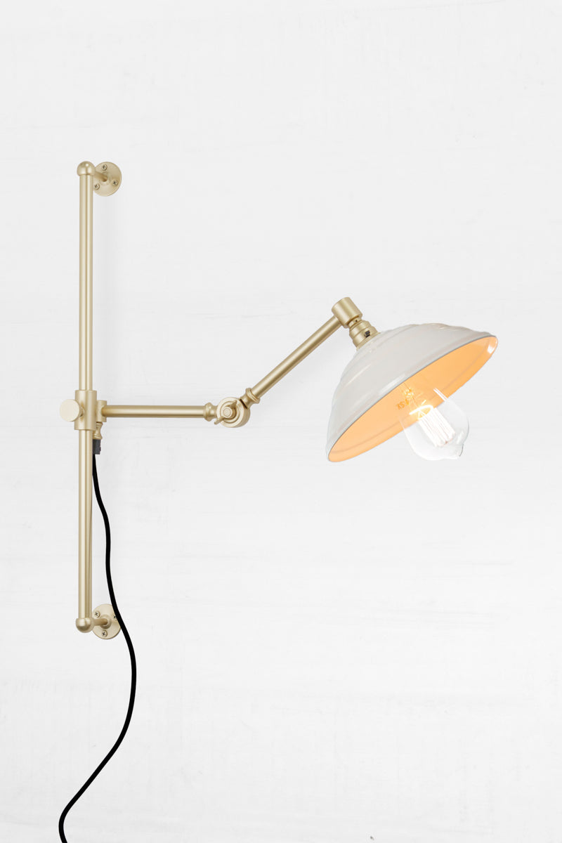 Swing Arm Wall Lamp in gold/brass arm finish with white Bakelite shade 