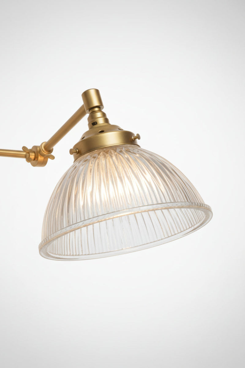 Clear readed glass shade on the gold/brass swing arm