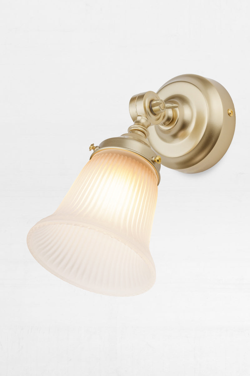Slightly extended adjustable wall batten in gold/brass with a small opal glass shade with ribbed detailing.