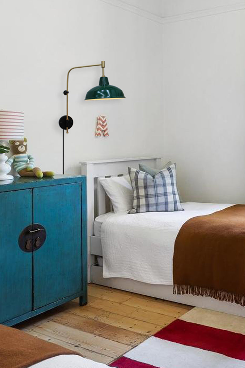 Gold/Brass wing arm wall light ih a federation green shade and wall plug as a bed side light. 