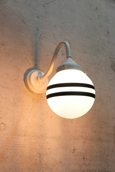 Hand painted opal glass ball pendant light with two stripes on white steel sconce.