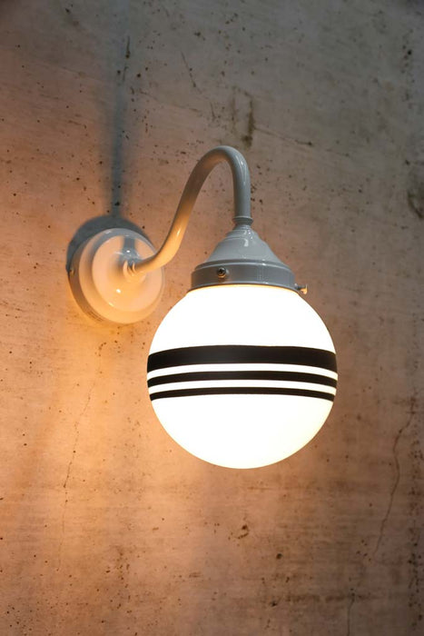 Hand painted opal glass ball pendant light with three stripes on white steel sconce.