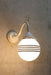 Hand painted opal glass ball pendant light with four stripes on white steel sconce.