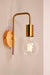 Timber wall light in gold/brass finish