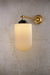 adjustable wall sconce in gold brass with reeded shade
