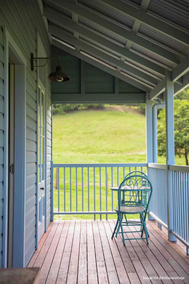 Railway wall light on a bllue watherboard house