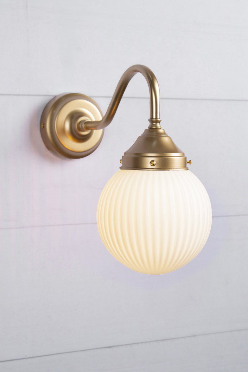 Opal glass ball shade with reeded detailing and an exterior gooseneck wall arm. 