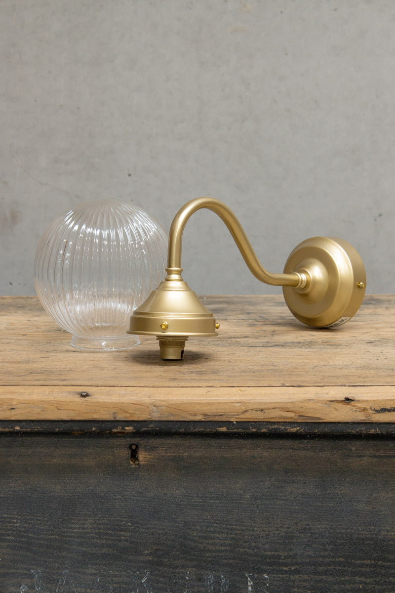 Exterior wall light with a gold/brass gooseneck arm and Clear reeded shade.