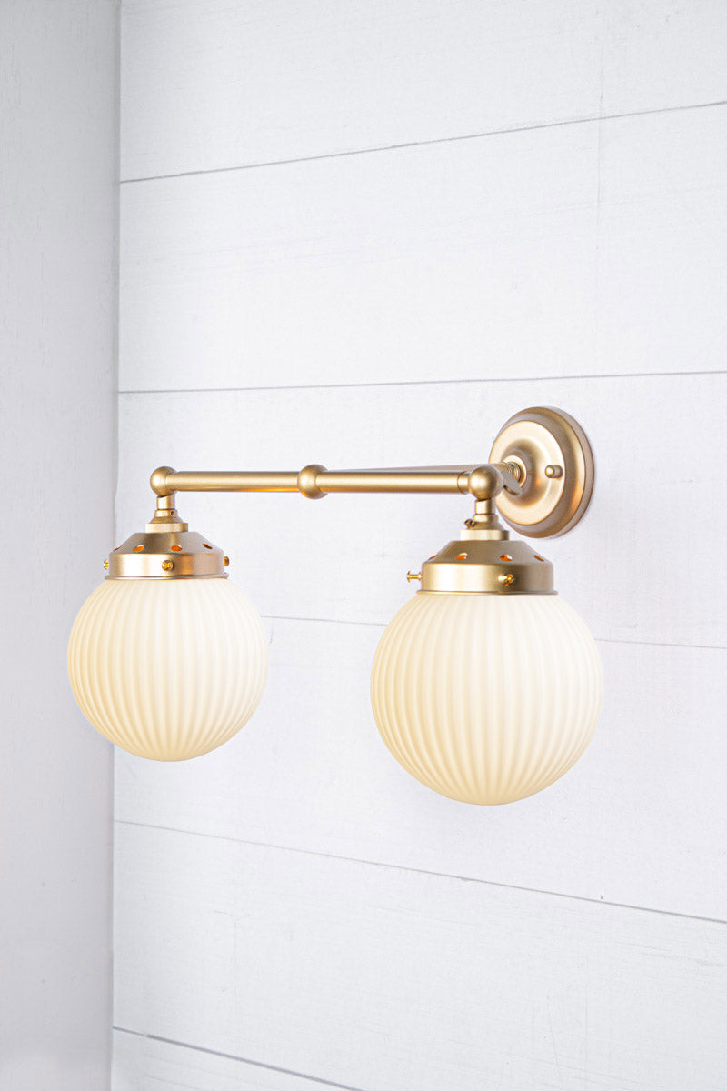 Opal shades with gold/brass double arm sconce