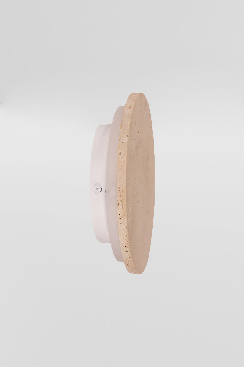 Side view of the small travertine circular back-lit LED wall light. 