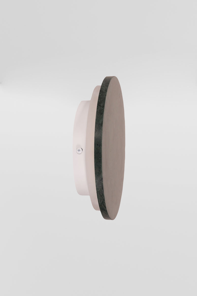 Side view of the small green marble circular back-lit LED wall light. 