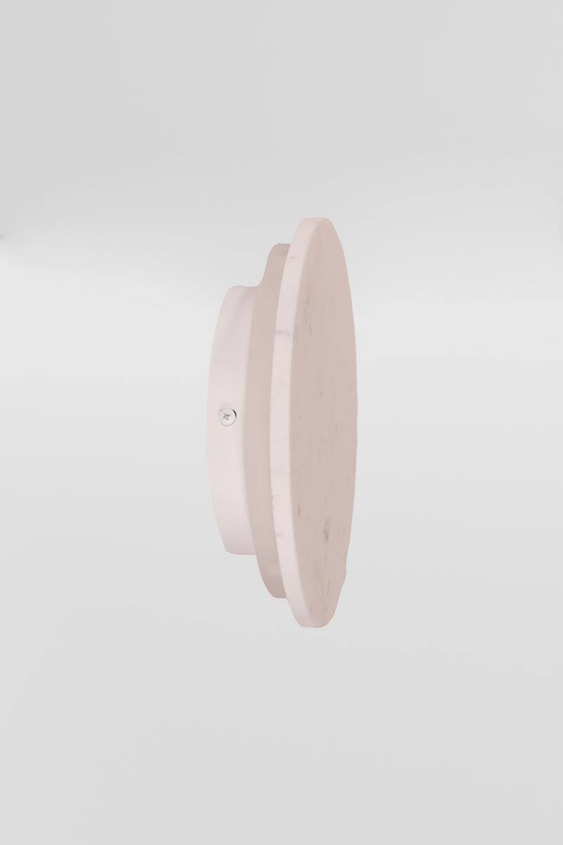 Side view of the small grey marble circular back-lit LED wall light. 