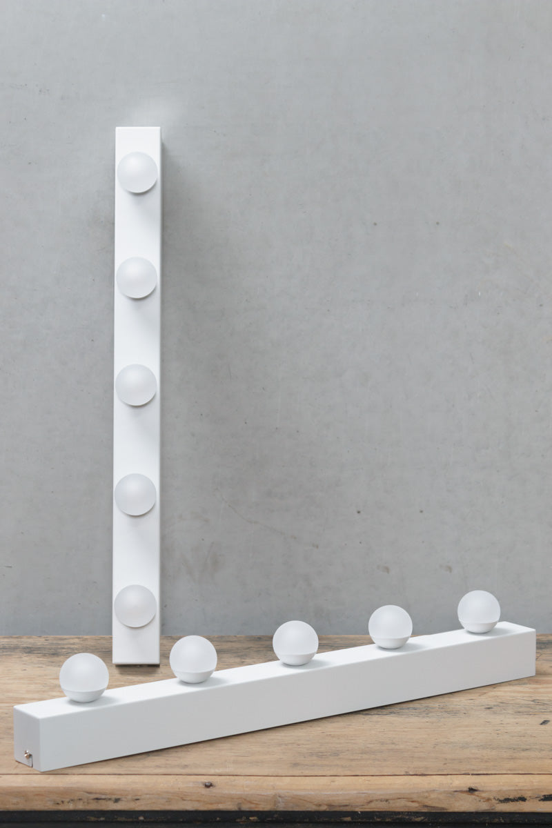 Two white strip vanity lights with 5 LED bulbs. 