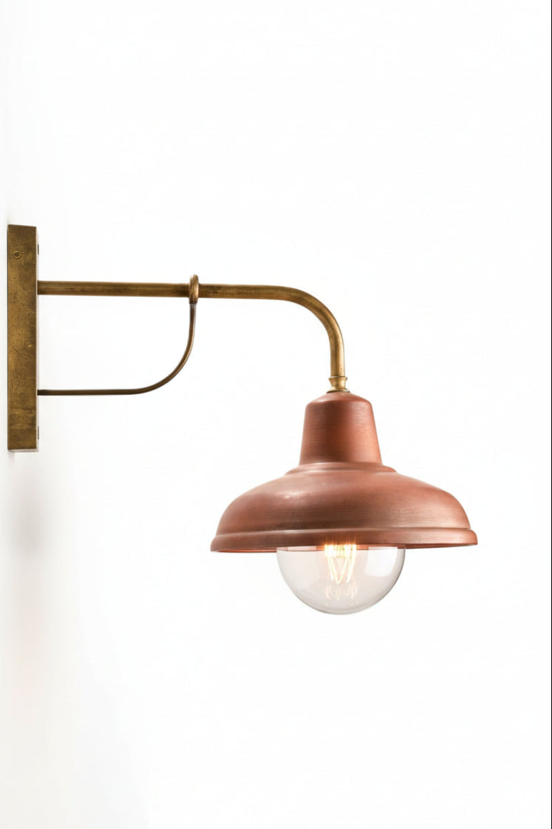Copper wall light with large clear bulb. 