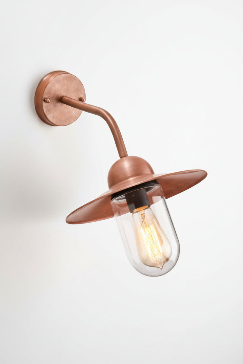 Copper wall light with glass cover. 