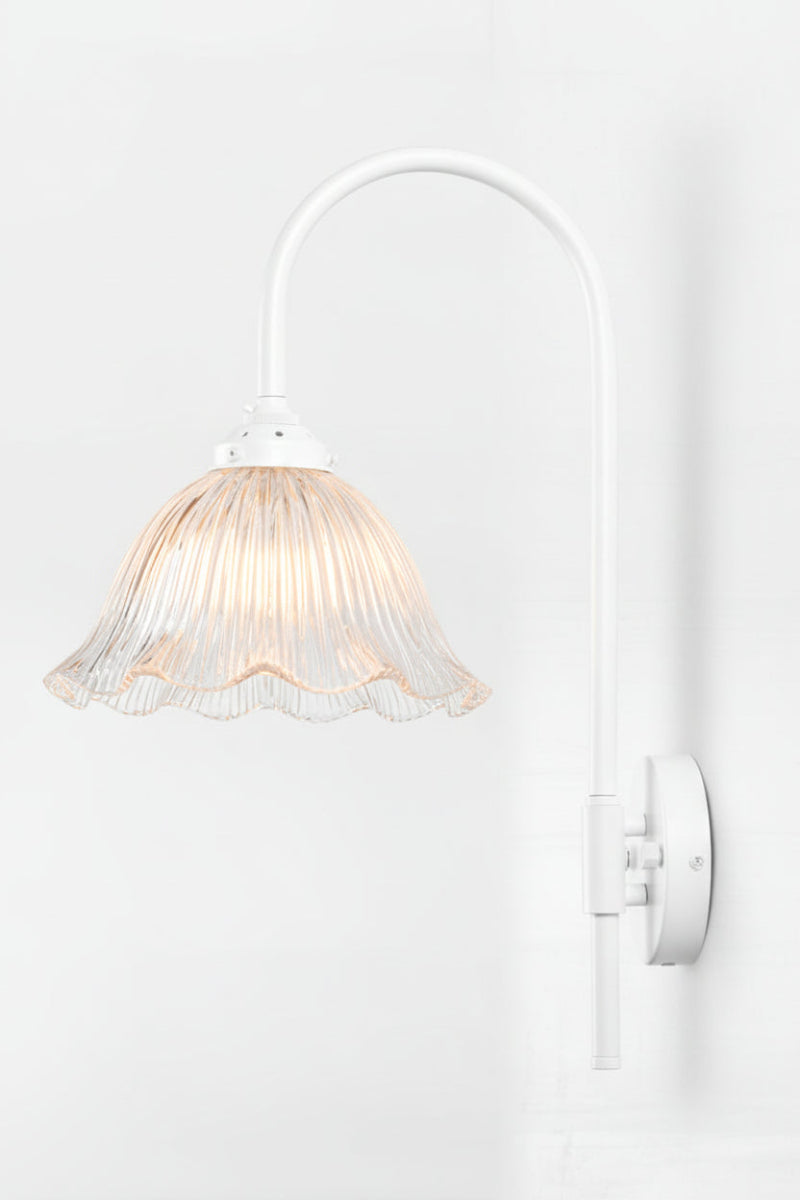 White shepards hook wall fixture with a large clear ribbed glass shade with rilled edging