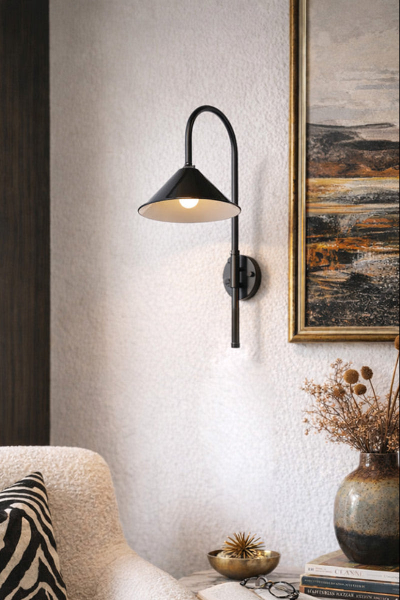 Shepard gooseneck wall light in black with a black cone shade as a reading nook light. 