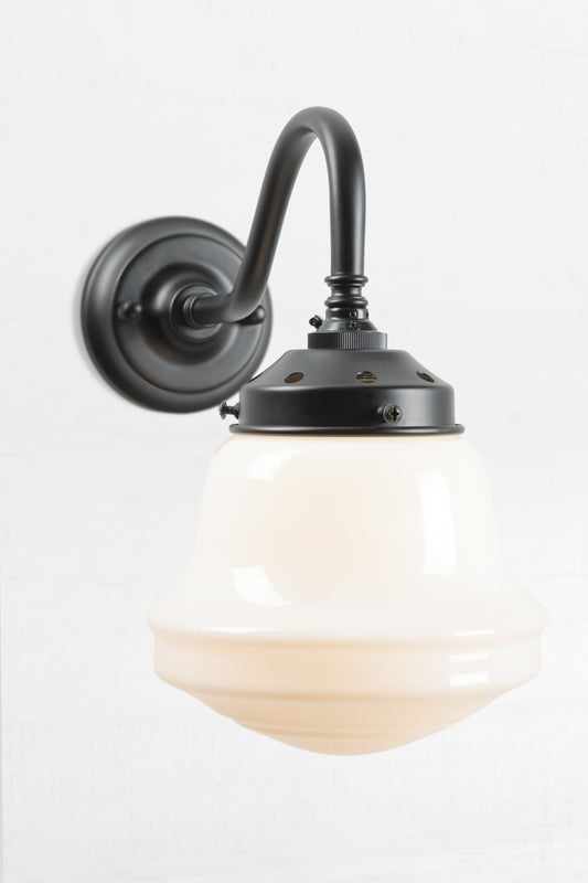 Side view of a Black gooseneck wall sconce with an opal schoolhouse style shade. 