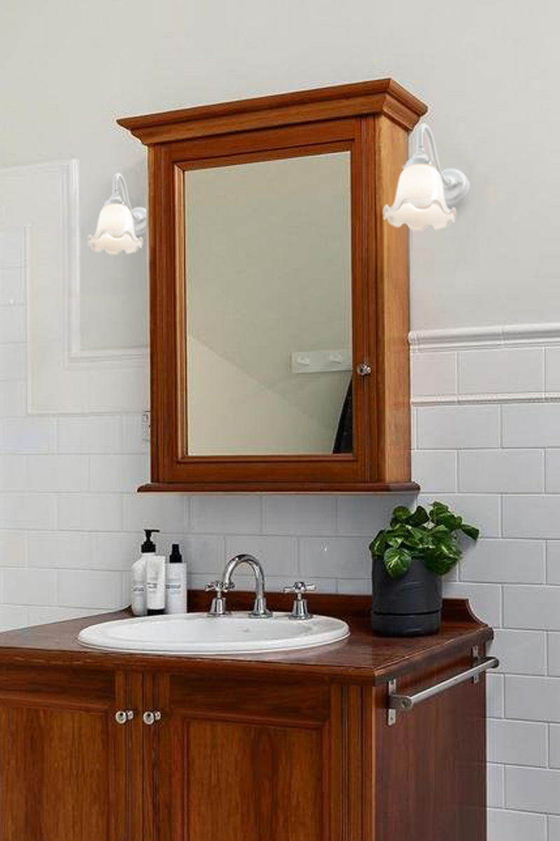 white wall sconces over bathroom