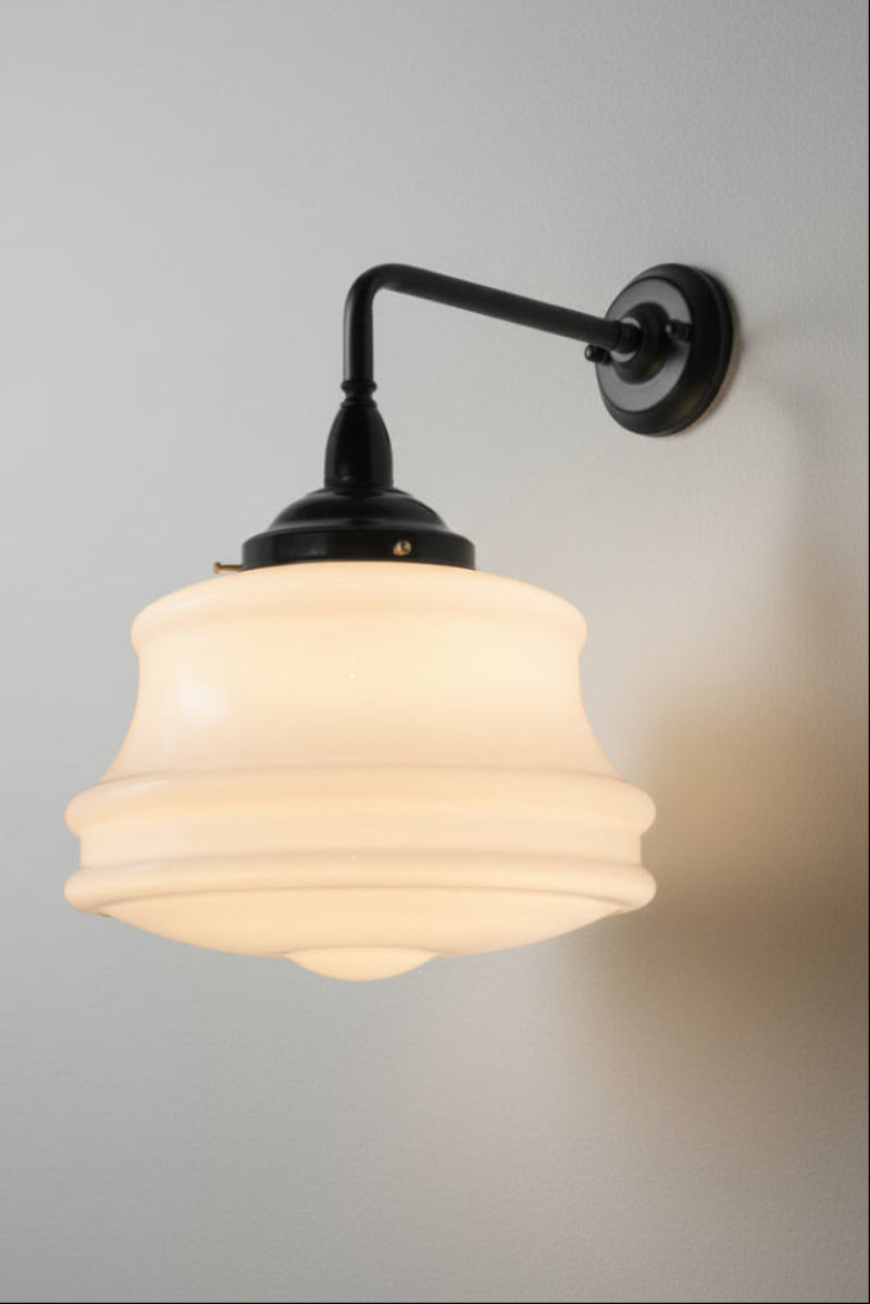 Large opal glass schoolhouse style shade on a black steel 90 degree wall sconce. 