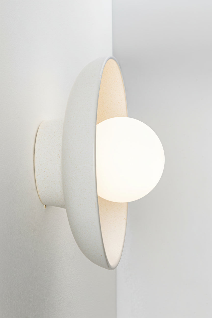 ceramic shade wall sconce with an opal glass ball shade. 