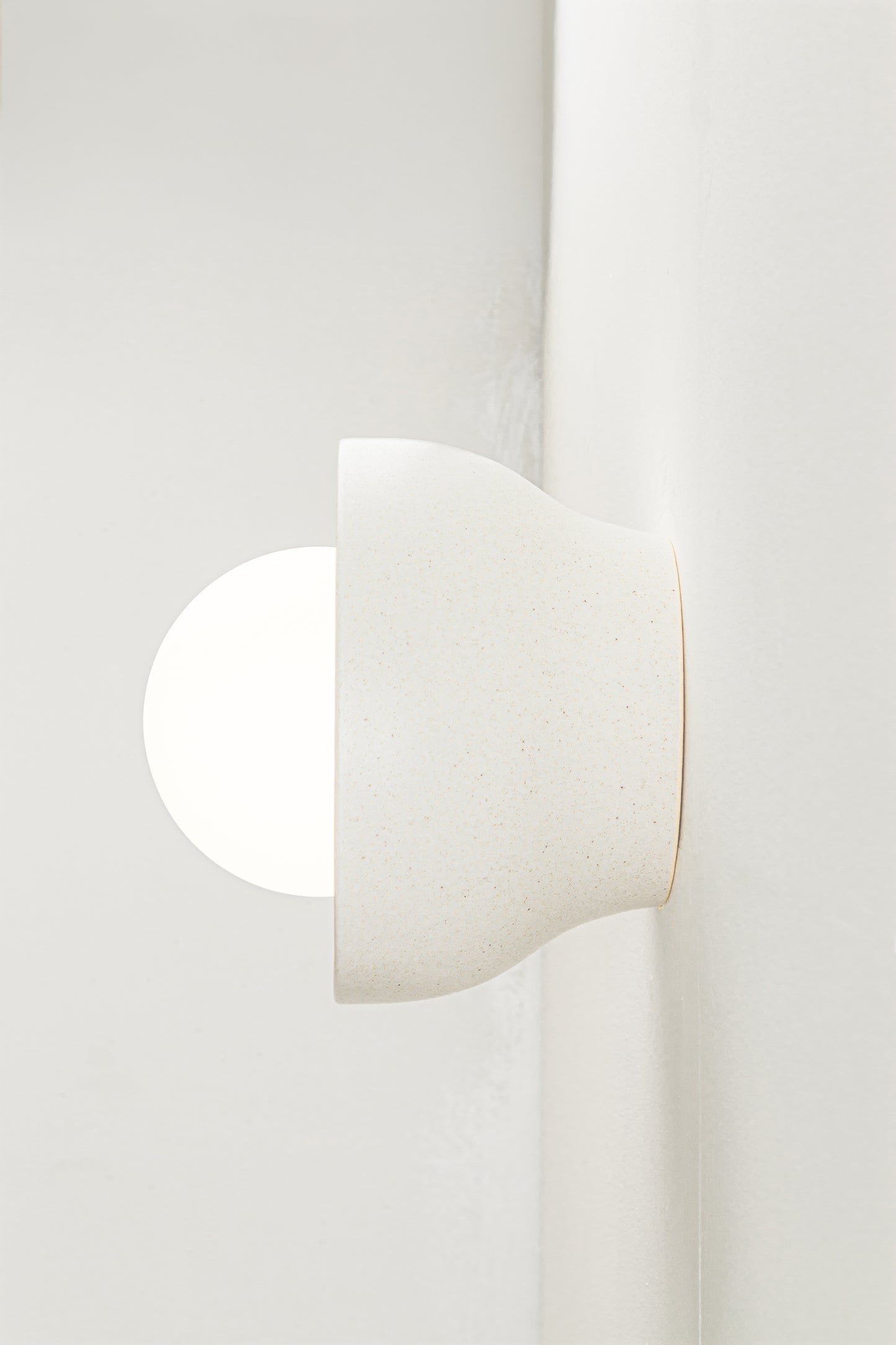 Ceramic construction with opal glass orb softens and diffuses light
