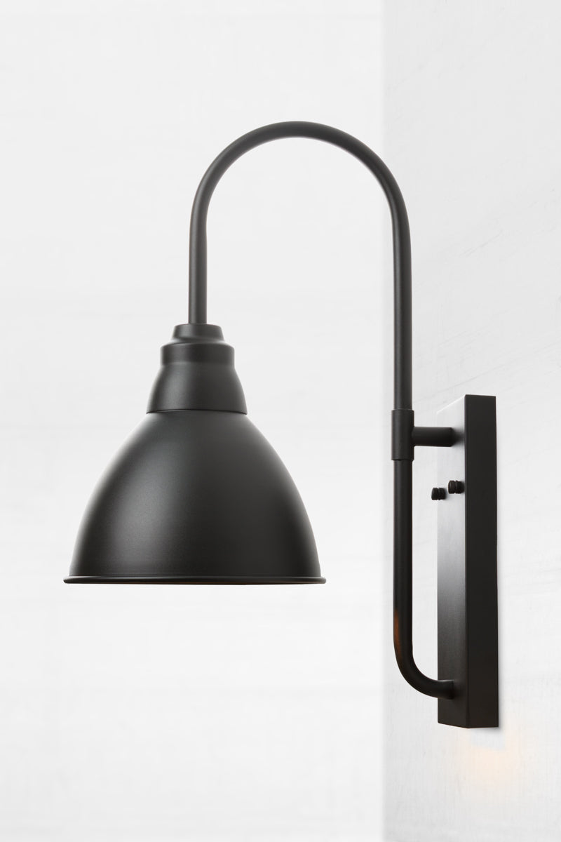 Side view of the large black wall light with goodsneck arm and dome shade. 