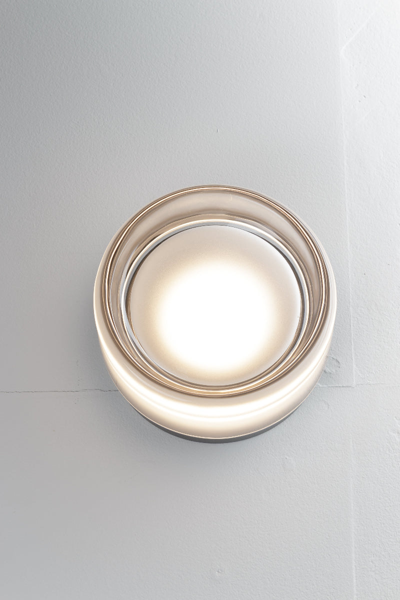 Frost eye catching wall light is comprised of a glass exterior over a built-in light source with dome diffuser.