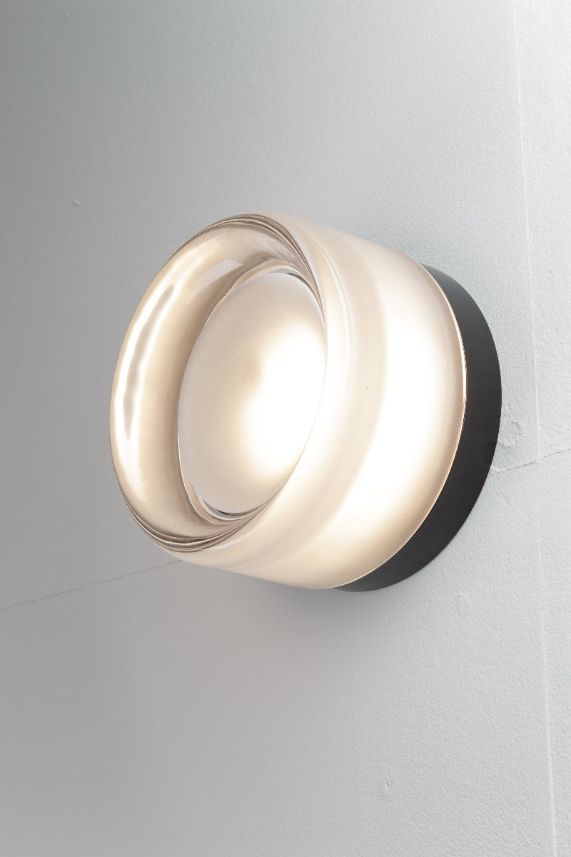 Side view of the frost eye catching wall light is comprised of a glass exterior over a built-in light source with dome diffuser.